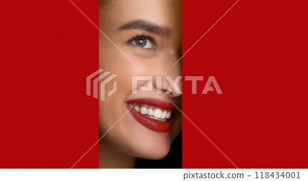 Makeup. Woman With Red Lips Peering Into Hole In Peach Paper, Copy Space 118434001