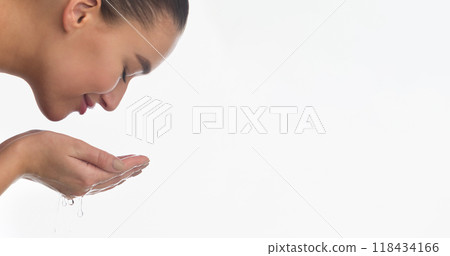 Morning Freshness. Woman Cleaning Face with Water, Removing Makeup on White Background Morning Freshness. Woman Cleaning Face with Water, Removing Makeup on White Background 118434166