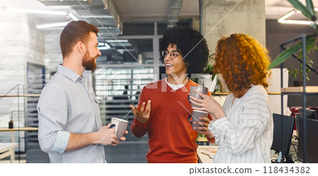 Coffee break of young creative team. Diverse millennials enjoying communication in modern office, free space 118434382