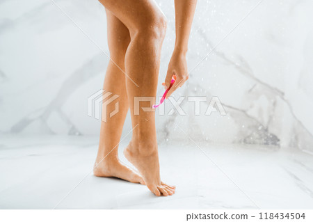 Depilation and bodycare concept. Woman shaving legs, taking shower, crop Depilation and bodycare concept. Woman shaving legs, taking shower, crop 118434504