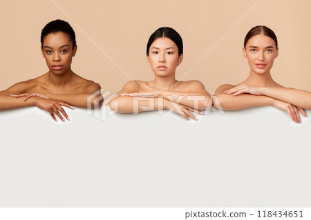 Three Multiethnic Ladies Standing Naked Posing Behind White Board For Text On Gray Background In Studio. Empty Space Three Multiethnic Ladies Standing Naked Posing Behind White Board For Text On Gray Background In Studio. Empty Space 118434651