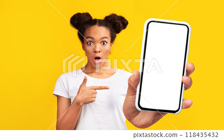 Unexpected Call. Amazed african american girl pointing at cell phone, staring at camera. Panorama, free space 118435432