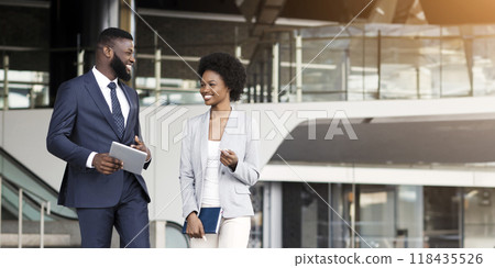 Happy african business partners leaving office building after successful meeting, cope space Happy african business partners leaving office building after successful meeting, cope space 118435526