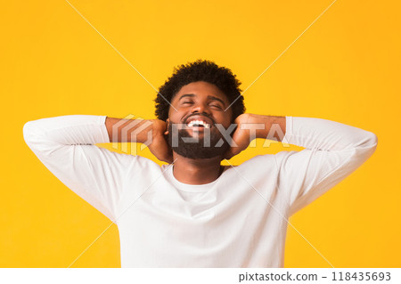Carefree african american guy leaning on his hands, with closed eyes smiling, panorama 118435693