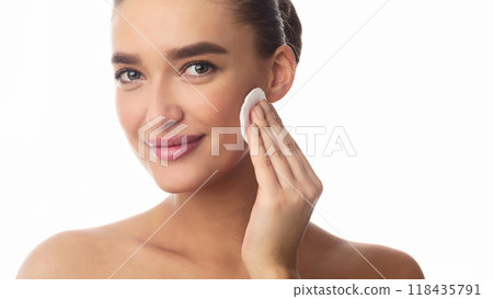 Removing Makeup. Woman Cleaning Face With Cotton Pad Over White Background 118435791