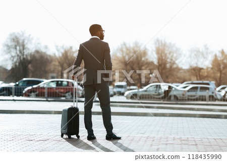 Wait for Airport Taxi. Businessman Arriving for Business Trip, Standing with Baggage Wait for Airport Taxi. Businessman Arriving for Business Trip, Standing with Baggage 118435990