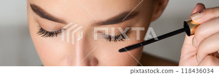 Woman Doing Makeup, Applying Black Mascara on her Eyelashes, Closeup, Panorama Woman Doing Makeup, Applying Black Mascara on her Eyelashes, Closeup, Panorama 118436034