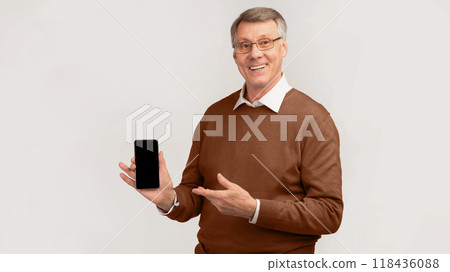 Great App. Cheerful Senior Man Showing Smartphone With Blank Screen Standing Over Gray Studio Background. Mockup, Panorama Great App. Cheerful Senior Man Showing Smartphone With Blank Screen Standing Over Gray Studio Background. Mockup, Panorama 118436088