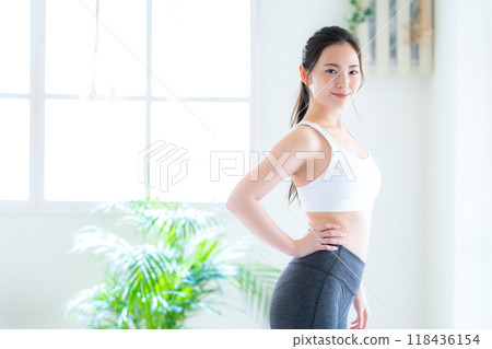 Young woman on a diet in the living room Young woman on a diet in the living room 118436154