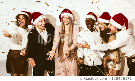 Xmas Mood. Young People Celebrating Christmas Catching Falling Confetti Having Fun Indoor. Panorama 118436171