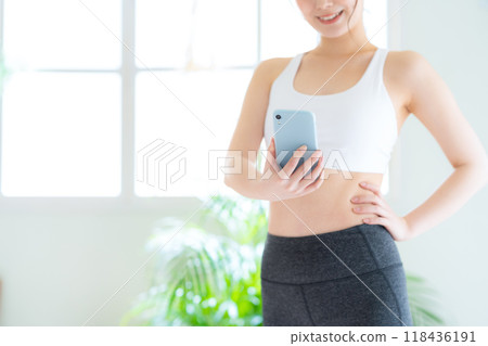 Young woman on a diet in the living room Young woman on a diet in the living room 118436191