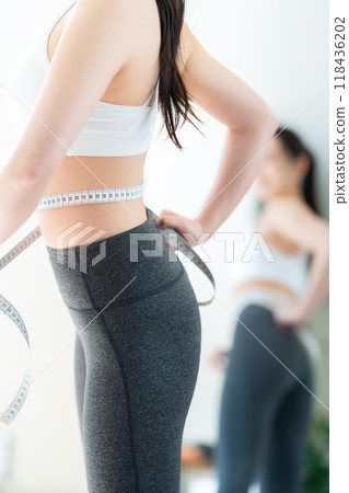 Young woman on a diet in the living room 118436202