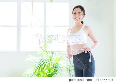 Young woman on a diet in the living room Young woman on a diet in the living room 118436203