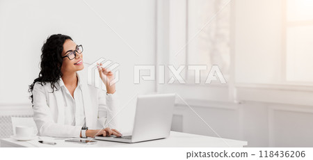 Thinking About Vacation. Happy hispanic businesswoman dreaming about holidays working at office, copyspace Thinking About Vacation. Happy hispanic businesswoman dreaming about holidays working at office, copyspace 118436206
