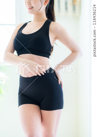 Young woman on a diet in the living room Young woman on a diet in the living room 118436214