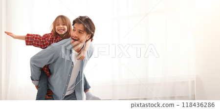 Cheerful Funny Father Is Playing With His Little Girl At Home, imitating airplane, empty space Cheerful Funny Father Is Playing With His Little Girl At Home, imitating airplane, empty space 118436286