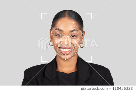 African American woman smiles while a digital facial recognition overlay highlights her features against a neutral backdrop. African American woman smiles while a digital facial recognition overlay highlights her features against a neutral backdrop. 118436328
