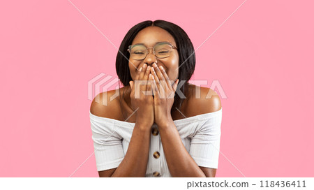 Laughter. Happy Black Girl Laughing Covering Mouth With Hands Standing On Yellow Background. Studio Shot, Panorama 118436411