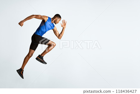 Doing Exercise. Full length portrait of muscular afro man with high knee, lifting leg and waving arm, copyspace 118436427