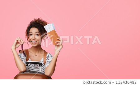 Female traveler with passport and ticket dreaming about trip, pink background 118436482
