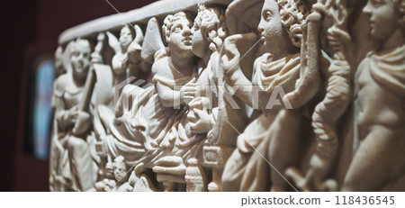 Close-up view on Ancient Marble Childs Sarcophagus. Roman Sarcophagus Or Coffin For Young Girl From Wealthy Family. Marble Carved With Scenes Of Wedding Of Greek Deities Cupid And Psyche. Sarcophagus Close-up view on Ancient Marble Childs Sarcophagus. Roman Sarcophagus Or Coffin For Young Girl From Wealthy Family. Marble Carved With Scenes Of Wedding Of Greek Deities Cupid And Psyche. Sarcophagus 118436545