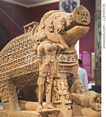 Close-up View On Varaha - Colossal Boar Is Third Incarnation Of Lord Vishnu. Varaha Is Depicted As Boar Or In Anthropomorphic Form, With Boar's Head And Human Body. Varaha and His Consort Bhumi Close-up View On Varaha - Colossal Boar Is Third Incarnation Of Lord Vishnu. Varaha Is Depicted As Boar Or In Anthropomorphic Form, With Boar's Head And Human Body. Varaha and His Consort Bhumi 118436556