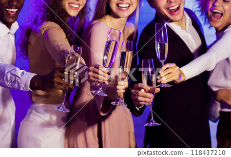 Group Of Smiling Millennials Clinking Champagne Glasses Celebrating Christmas Or New Year Having Fun At Party Indoor, Cropped Group Of Smiling Millennials Clinking Champagne Glasses Celebrating Christmas Or New Year Having Fun At Party Indoor, Cropped 118437210