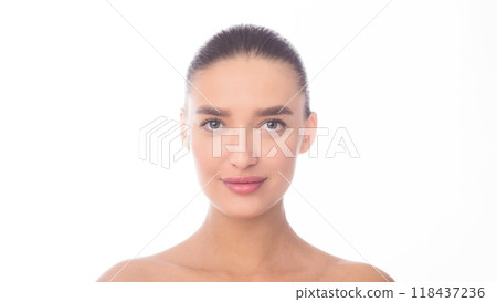 A close-up view of a woman face against a plain white background. Her features are visible, including her eyes, nose, mouth, and hair. The woman appears calm and composed in the photo. 118437236