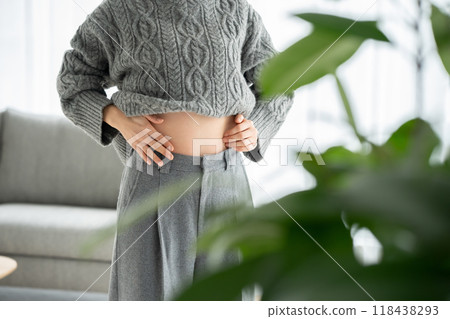 Woman touching her stomach, diet, hand Woman touching her stomach, diet, hand 118438293