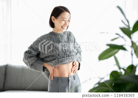 Woman touching her stomach, diet, smiling 118438305