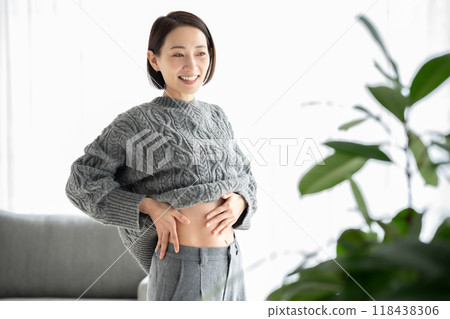 Woman touching her stomach, diet, smiling 118438306