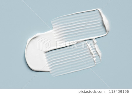 Smear of cream on a blue background. Smear of cream on a blue background. 118439196