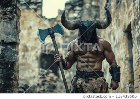 A shirtless, muscular warrior wearing a horned helmet and holding a battle axe, standing among ancient stone ruins, embodying strength and fantasy 118439500
