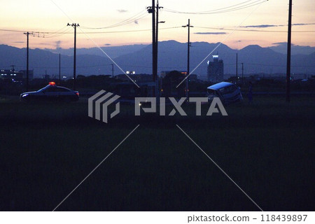 Traffic accident on a farm road at dusk 118439897