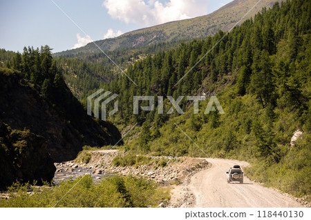 Japanese SUV moving by a road near a mountain river 118440130