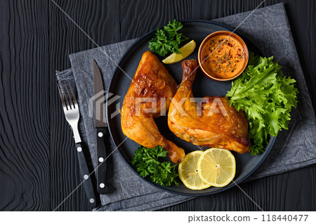 fried chicken legs with lettuce, lemon on plate 118440477