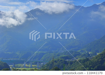 Cloud-covered mountains and the Chuo Line crossing Torisawa Bridge Cloud-covered mountains and the Chuo Line crossing Torisawa Bridge 118441170