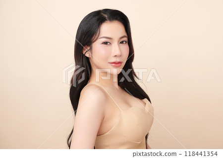 Beautiful young asian woman with clean fresh skin on beige background, Face care, Facial treatment, Cosmetology, beauty and spa, Asian women portrait. 118441354