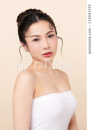 Beautiful young asian woman with clean fresh skin on beige background, Face care, Facial treatment, Cosmetology, beauty and spa, Asian women portrait. 118441355