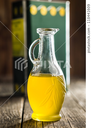 Bottle of organic unfiltered extra virgin olive oil on wooden table. 118441609