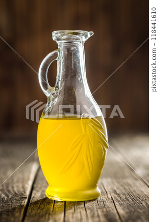 Bottle of organic unfiltered extra virgin olive oil on wooden table. 118441610