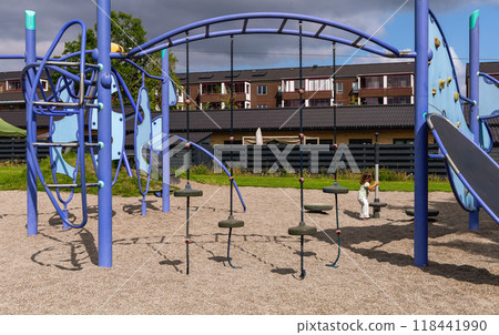 Playground next to the house with a little girl Playground next to the house with a little girl 118441990