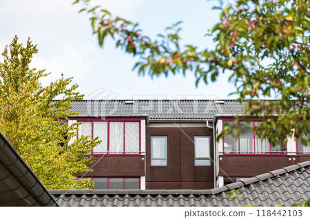Residential building with new roof. Real estate investment. Expensive housing. Residential building with new roof. Real estate investment. Expensive housing. 118442103