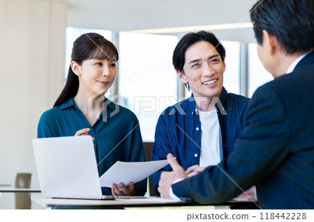 A middle-aged couple consulting each other. Photo courtesy of Denpa Gakuen, Tokyo Electronics College. 118442228