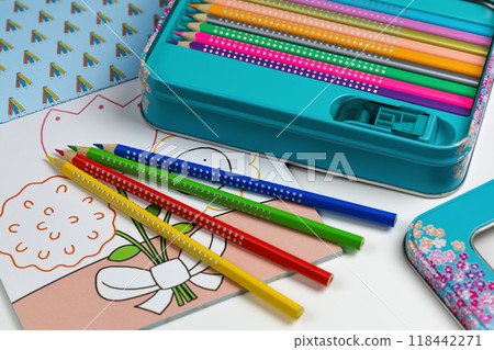 Colored pencils for drawing various colors and coloring book for children. 118442271