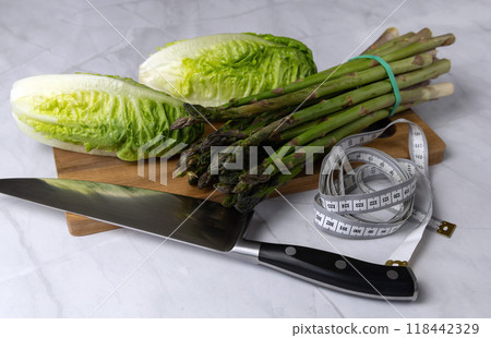 Fresh vegetables on the kitchen table cabbage, salad, asparagus. 118442329