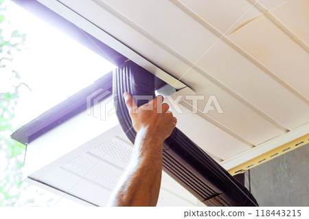 It is being assembled by handyman along with installation of gutter channels attached to roof It is being assembled by handyman along with installation of gutter channels attached to roof 118443215