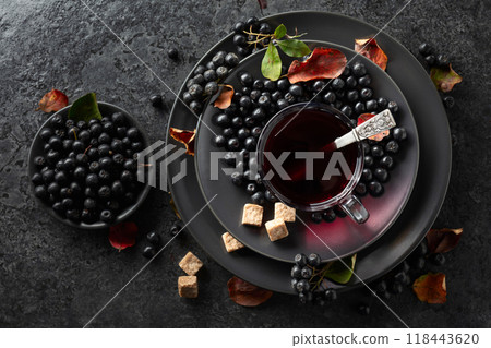 Black chokeberry juice, fresh berries, and pieces of brown sugar. Black chokeberry juice, fresh berries, and pieces of brown sugar. 118443620