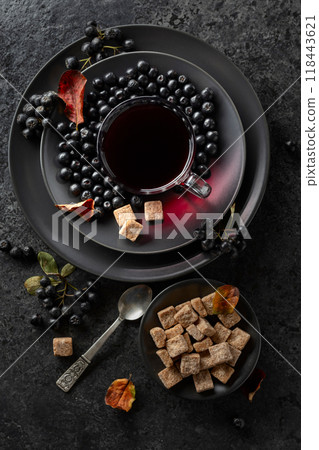 Black chokeberry juice, fresh berries, and pieces of brown sugar. Black chokeberry juice, fresh berries, and pieces of brown sugar. 118443621