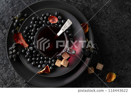 Black chokeberry juice, fresh berries, and pieces of brown sugar. 118443622